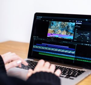 Young content creator girl editing video on her laptop. Working from home